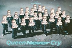 a group of young children standing next to each other in front of a sign that says queen never cry