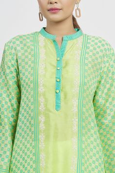 Lime asymmetric tussar tunic with striped panels, geometric block print, front buttons and floral embroidery.
Component: 1
Pattern: Printed
Type Of Work: Geometric
Neckline: Mandarin
Sleeve Type: Full Sleeves
Fabric: Tussar
Color: Green
Other Details: 
Block print
Note: Pant worn by the model is not for sale
Occasion: Puja,Work - Aza Fashions Green Block Print Kurta For Spring, Spring Green Block Print Kurta, Green Tunic For Eid, Green Long Sleeve Tunic With Printed Motifs, Green Straight Kurta Tunic For Eid, Green Straight Kurta Top For Eid, Green Fitted Straight Kurta Top, Green Straight Kurta Blouse, Green Tops With Printed Motifs For Eid