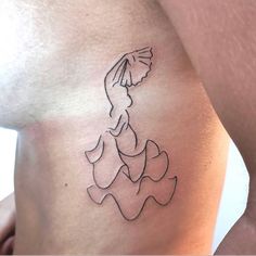 a woman's stomach with a tattoo of a lady in a dress on it