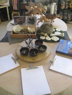 the table is set up with several items for making paper sculptures and other crafting supplies