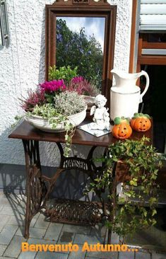 a table with flowers and pumpkins on it in front of a mirror that says interest