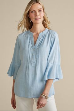 Fresh, feminine, and easy-breezy, this pullover style is a versatile addition to your everyday wardrobe. Ruffle cuffs sway on the 3/4-length sleeves, while a curved hem, 3/4 button placket, and Mandarin collar create a polished silhouette. Spring Linen Tops With Roll-up Sleeves, Summer Tops With Roll-up Sleeves For Casual Gatherings, Spring Tops With Roll-up 3/4 Sleeves, Chic Spring Tops With Roll-up Sleeves, Spring 3/4 Sleeve Tops For Casual Gatherings, 3/4 Sleeve Tops For Spring Casual Gatherings, 3/4 Sleeve Tops For Casual Spring Gatherings, Relaxed Fit Tops With Roll-up Sleeves For Spring, Spring Casual Gatherings Tops With 3/4 Sleeves