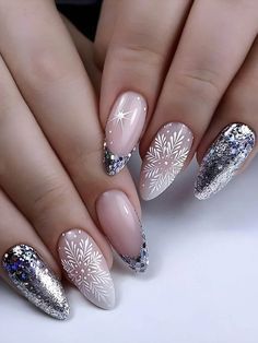 a woman's hands with white and silver manies on their nails, decorated with snowflakes