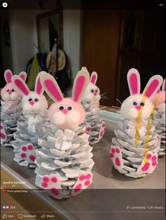 some paper cups with bunny decorations on them and one is made out of pine cones