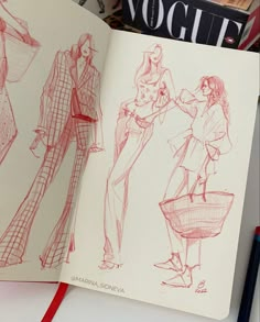 an open book with drawings of women's clothing