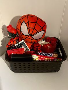 a basket filled with assorted items on top of a white counter next to a red rose