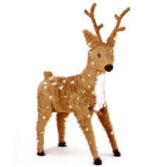 a lighted reindeer standing next to a white background