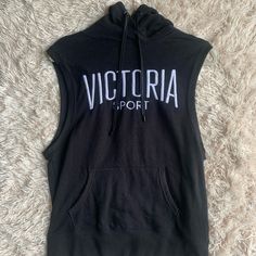 Brand: Victoria Sport Color: Black Hood Muscle Tank Top Sweatshirt Material Never Worn Black Sportswear Top With Drawstring Hood, Black Hooded Workout Top, Black Workout Tops With Drawstring Hood, Victoria's Secret Sporty Tops For Sports, Black Hoodie Tops In Athleisure Style, Black Athleisure Top With Drawstring Hood, Victoria's Secret Sporty Tops For Fall, Victoria's Secret Winter Casual Tops, Victoria's Secret Casual Winter Tops