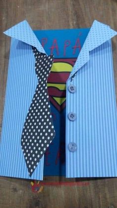 an origami superman shirt and tie with the word papa on it, cut out from paper