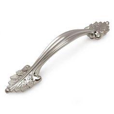 an antique style metal handle on a white background