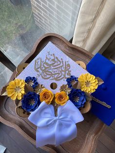 a graduation cap decorated with flowers on a chair