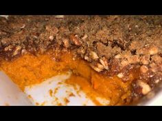 a casserole dish filled with sweet potatoes and topped with crumbled toppings