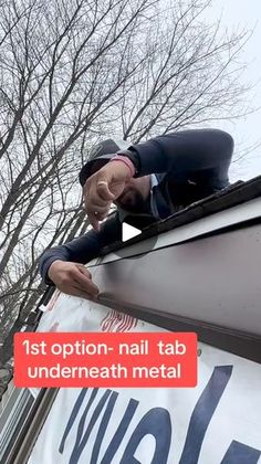 a man is standing on top of a metal roof