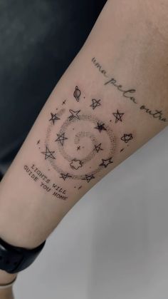 a person with a tattoo on their arm that reads, we are all here and there is only one star