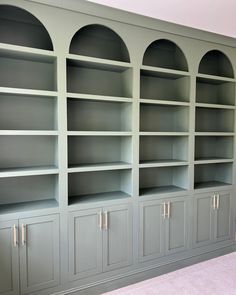 an empty bookcase in the corner of a room