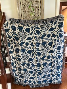 a blue and white blanket sitting on top of a wooden banister