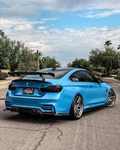 a blue sports car parked on the side of the road