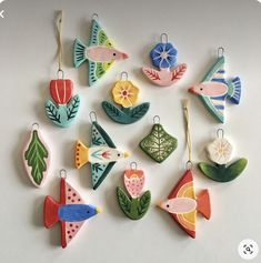 an assortment of ceramic ornaments on a white surface