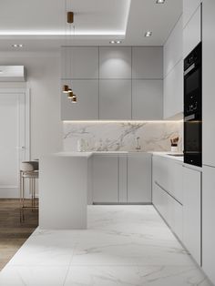 a modern kitchen with marble counter tops and white cabinets