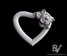 a white heart shaped object with a rose on it's end and the letter b in the middle