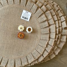 the table is made out of burlap and has three flowers on each side