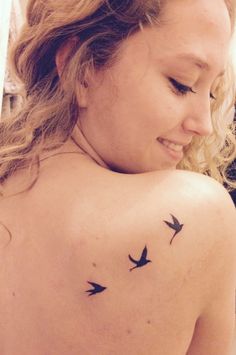 a woman with two birds on her back