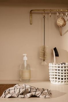 a white basket sitting on top of a counter next to a hair dryer and brush