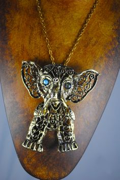 "How adorable is this Indian Elephant? Wonderful articulated Elephant Pendant with Red eyes or Blue eyes and moving head. This fun and fabulous pendant is from the DeLizza & Elster Juliana Costume Jewelry Design House from DeLizza's Puppet Jewelry!. Measures 3.5\" x 3.5\", gold toned. Chain included. Never before worn or owned." Indian Elephant, Elephant Pendant, Red Eyes, Design House, Miami Beach, Puppets, Blue Eyes, Pendant Necklaces, Costume Jewelry