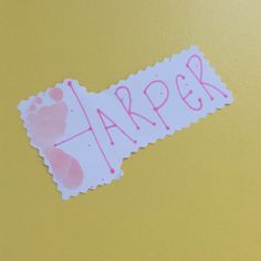 a piece of paper with the word harper written on it and a pink hand print