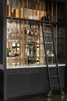 a ladder is leaning against the wall in front of a bar filled with bottles and glasses