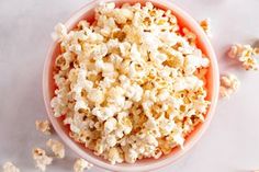 a bowl filled with popcorn sitting on top of a table