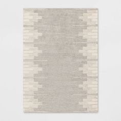 a white rug with an abstract design on it