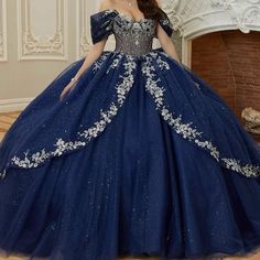 a woman in a blue ball gown posing for the camera