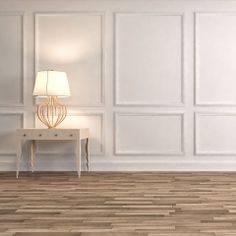 an empty room with white walls and wood flooring is pictured in this image, there are two lamps on the end table