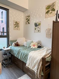 a bed room with a neatly made bed and lots of lights on the wall above it