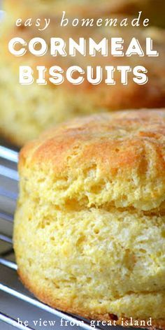 two cornmeal biscuits sitting on top of a cooling rack with the words easy homemade cornmeal biscuits