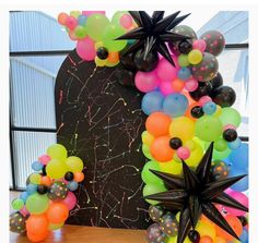 an arrangement of balloons and stars on a table