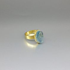 The sides of this raw stone ring are polished to secure a firm hold and give a the opportunity to cut a geometrical shape. It is set in 18K gold with a 4mm / 0.15inches band and a small rim embracing the stone. The stone is of high quality and stunns with its beautiful color. All our stones are natural stones and our jewelry is handmade, very slight differences may occur in color and size. Size stone: 14x8x8mm Aquamarine: The Romans believed it was sacred to Neptune and was a gift by the sirens, Oval Large Stone Topaz Ring For Anniversary, Oval Topaz Ring With Large Stone For Anniversary, Oval Sapphire Ring With Large Stone As Gift, Oval Blue Topaz Rings Suitable For Gifts, Oval Large Stone Sapphire Ring Gift, Modern Blue Topaz Oval Ring, Modern Oval Blue Topaz Ring, Modern Aquamarine Oval Rings, Oval Blue Topaz Rings For Gifts