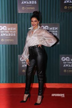 an image of a woman on the red carpet wearing black leather pants and high heels