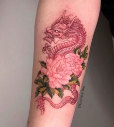 a dragon and peony tattoo on the arm