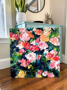 an image of a painting on the side of a dresser with flowers painted on it