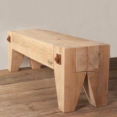 a wooden bench sitting on top of a hard wood floor