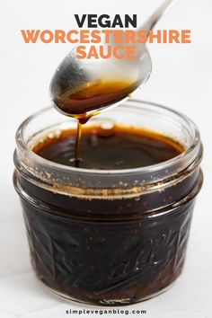 a spoon full of barbecue sauce with the words vegan wortster - shire sauce above it