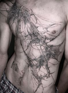 a man with no shirt on has his chest covered in black and white inks