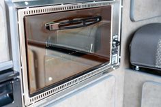 a microwave oven sitting on top of a counter next to a wall mounted heater