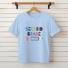 First Grade Shirt, Second Grade Tshirt, Third Grade shirt, Fourth, Fifth Grade Shirt,  Kinder Garten Tshirt,  Back To School Shirt "Welcome to our online shop, where comfort meets style in every stitch! Our custom t-shirts are all about feeling cozy and looking stunning. They're made from super soft fabrics and come in a bunch of awesome colors that really stand out. Whether you're into bright and bold or more subtle shades, we've got something that'll suit your vibe perfectly. HOW TO ORDER 𝟏. Choose shirt color. 𝟐. Select shirt size. 𝟑. Select quantity. 𝟒. Click add to cart. For multiple items, go back to the list and repeat the steps. SIZING & MATERIALS Printed on Unisex Gildan Soft Style and Bella Canvas T- Shirt for a relaxed fit; the fabric brings extra coziness to your wardrobe w Blue Letter Print Top For School, Blue Letter Print Tops For School, Graphic Tee With Sublimation Print For School, Basic Short Sleeve Shirt With Letter Print, Blue Short Sleeve Shirt With Text Print, School Tops With Sublimation Print And Short Sleeves, Blue School Tops With Text Print, Blue Text Print Tops For School, Blue Pre-shrunk T-shirt For School