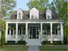 a white two story house with porches and columns