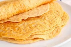 a stack of pancakes on a white plate