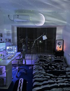 a bed room with a neatly made bed next to a desk and computer on top of it