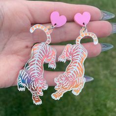 "Big and beautiful! Iridescent tigers attached to pink heart shaped studs. The tigers feature hand painted details and measure 2.5\" tall." Shrinky Dink Earrings, Tiger Earrings, Weird Jewelry, Laser Cut Jewelry, Laser Cut Acrylic, Plastic Jewelry, Glitz And Glam, Pink Heart, Red Roses